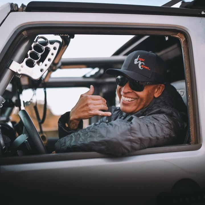 CMM Offroad driver holding knuckle grab handle inside Jeep — available from Offroad Trading Company