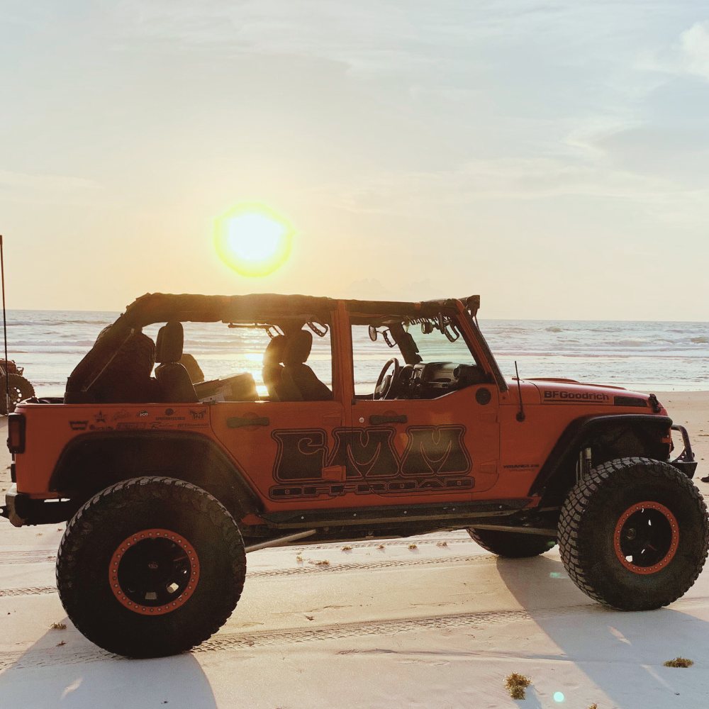 CMM Offroad red Jeep with open doors and grab handle accessories — available from Offroad Trading Company