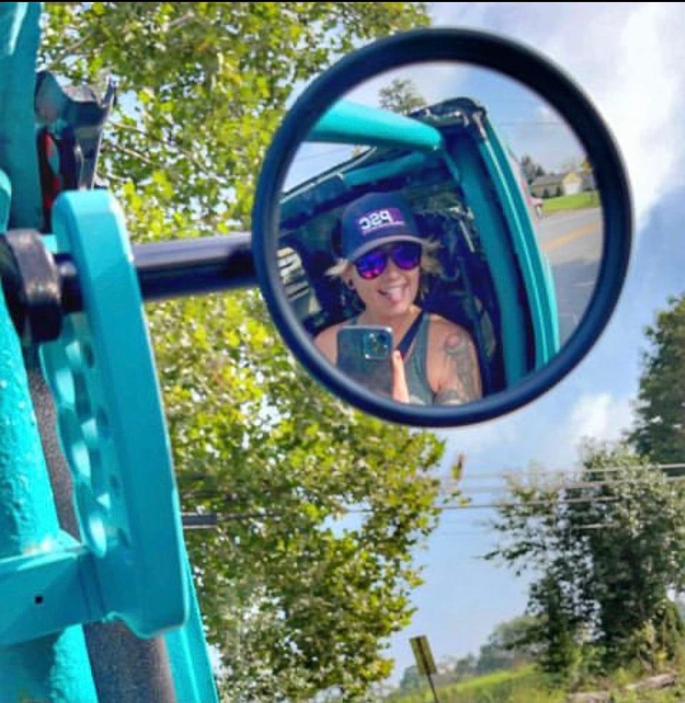 CMM Offroad round mirror beside turquoise Jeep cage — available from Offroad Trading Company