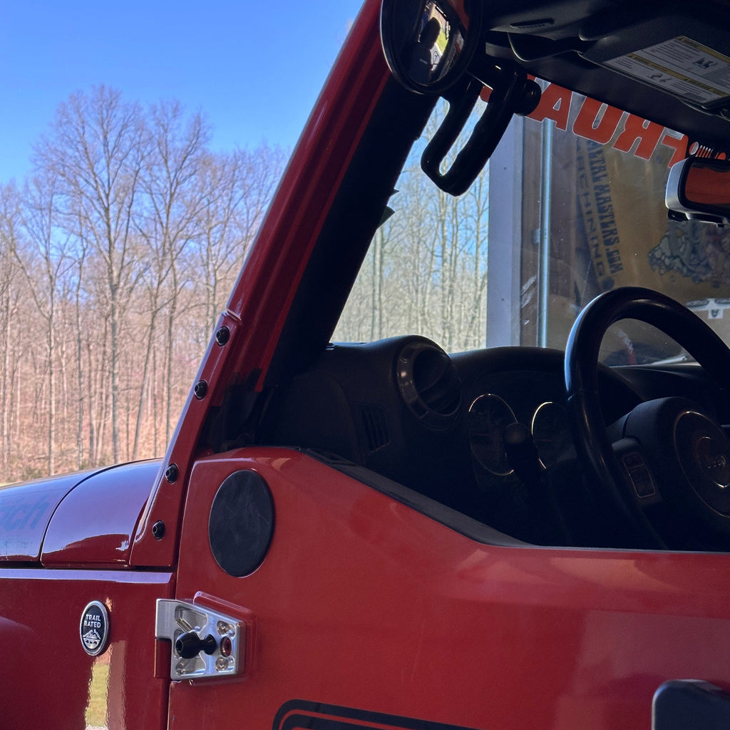 CMM Offroad billet door hinge installed beside Jeep door opening — available from Offroad Trading Company