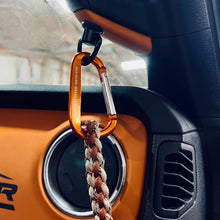 Load image into Gallery viewer, CMM Offroad quick-disconnect attachment holding keys beside Jeep dashboard — available from Offroad Trading Company