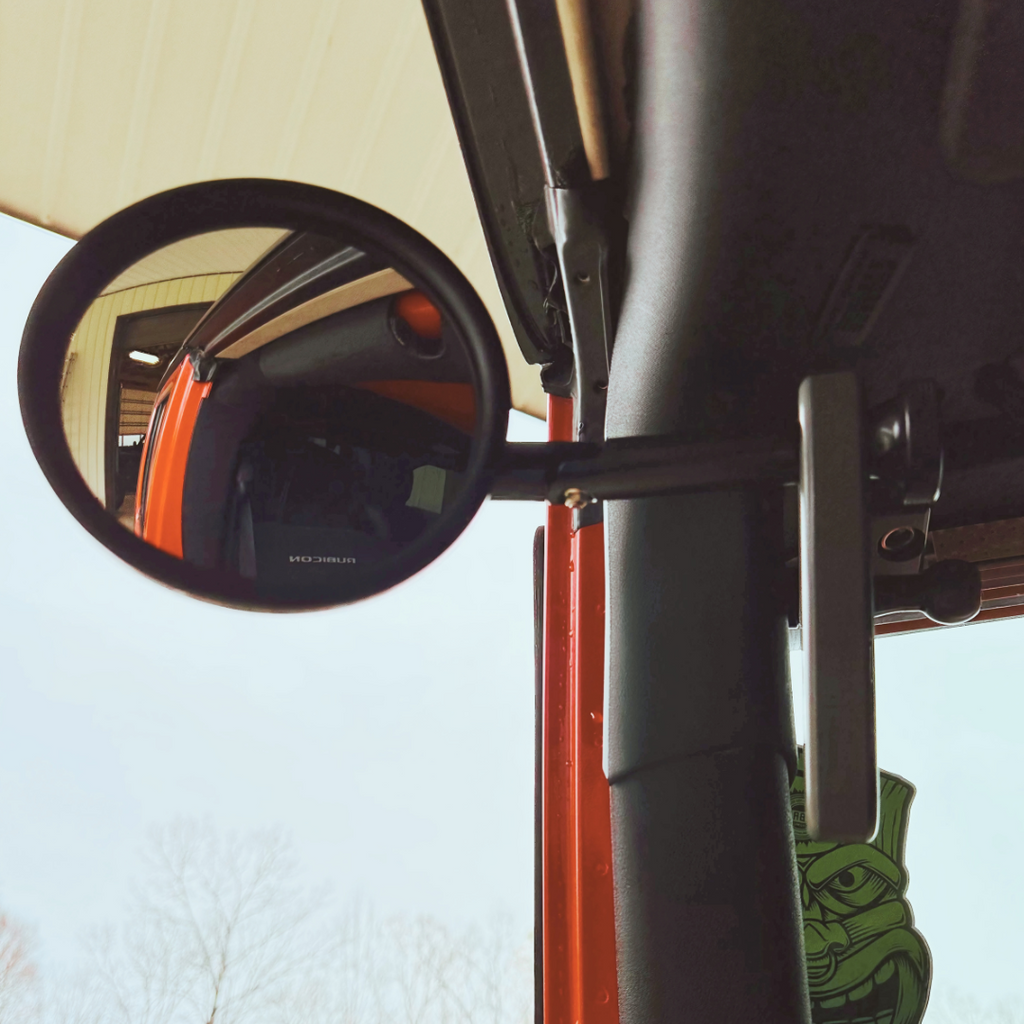 CMM Offroad round mirror beside red grab handle — available from Offroad Trading Company