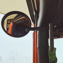 Load image into Gallery viewer, CMM Offroad round mirror beside red grab handle — available from Offroad Trading Company