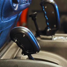 Load image into Gallery viewer, CMM Offroad Jeep center console with billet shifter installed — available from Offroad Trading Company