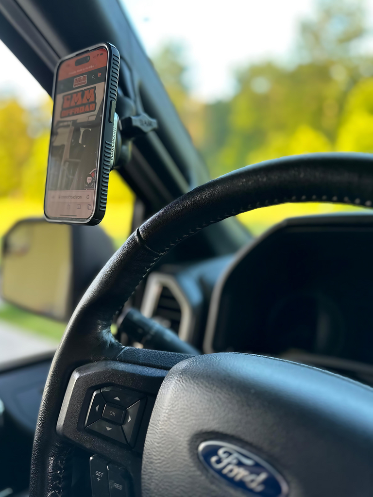 CMM Offroad phone attached beside steering wheel — available from Offroad Trading Company
