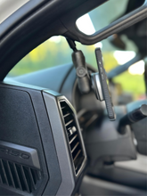 Load image into Gallery viewer, CMM Offroad mounting arm installed beside vehicle dashboard — available from Offroad Trading Company