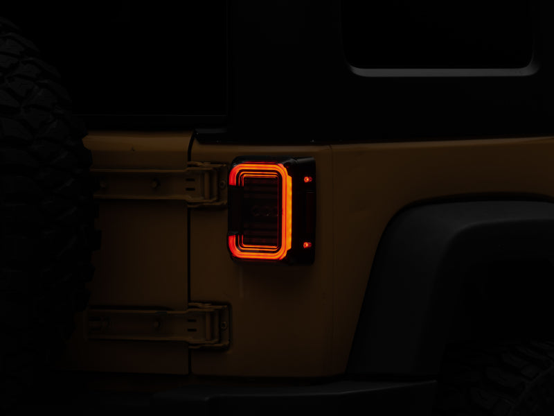 Raxiom Tail Lights Raxiom 07-18 Jeep Wrangler JK Axial Series LED Halo Tail Lights- Black Housing (Dark Smoked Lens)